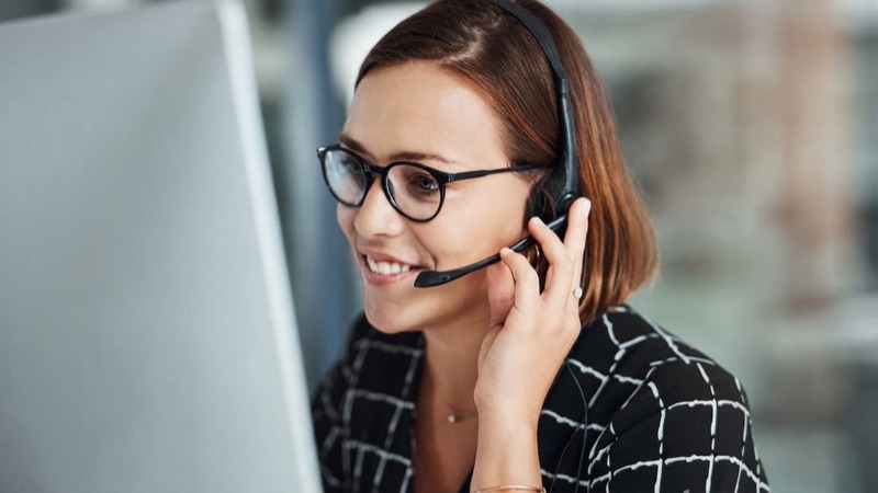 Bilingual coordinator wearing a headset while assisting a patient